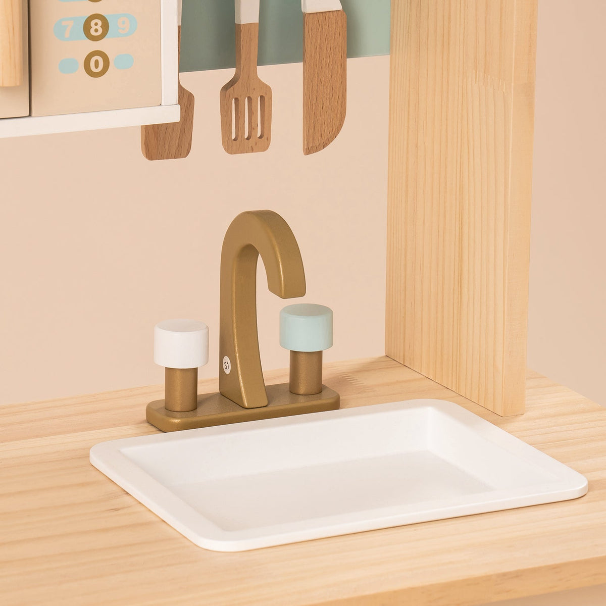 ROBUD kitchen sink detail featuring a white basin with brass-tone twin-handle wooden faucet