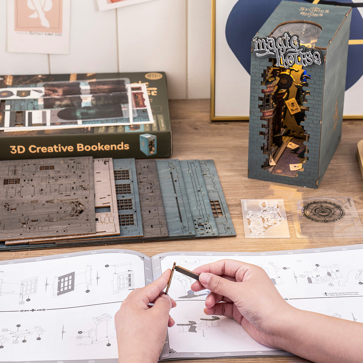 Rolife 3D Creative Bookends retail boxes with assembly instructions and a person sketching plans