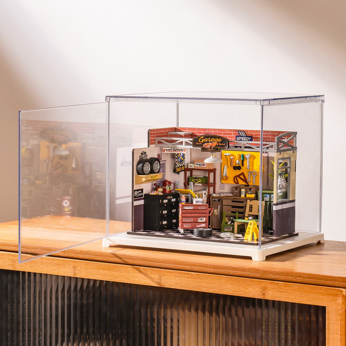 Rolife Garage Workshop in a clear display box is shown at an angle on a cabinet.