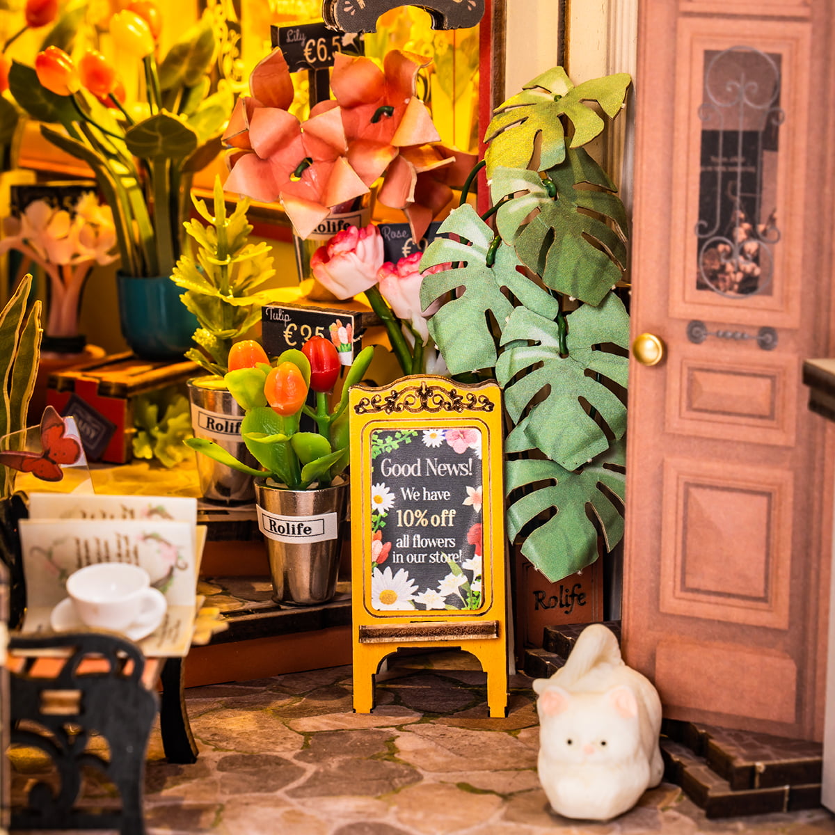 Rolife Floral Corner book nook close up showing flower shop with pink blooms, chalkboard sign and white cat