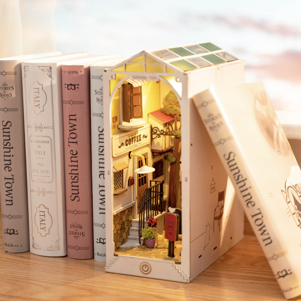 Rolife Sunshine Town book nook showing Mediterranean alley scene with tiled stairs and balcony between matching hardcover books