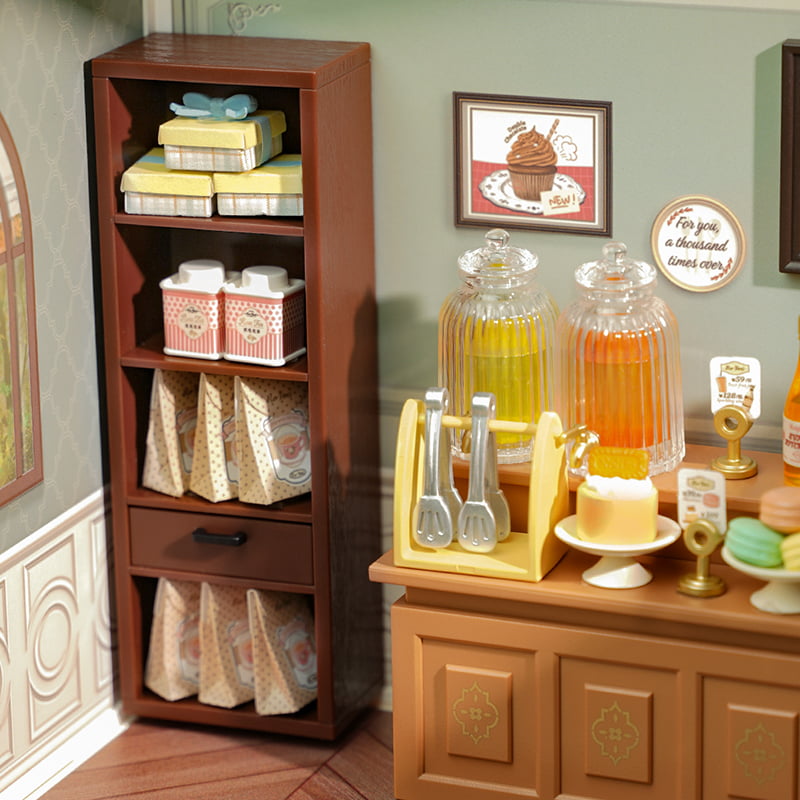 Rolife bookshelf and drink counter corner with bottles, towels and framed dessert wall art
