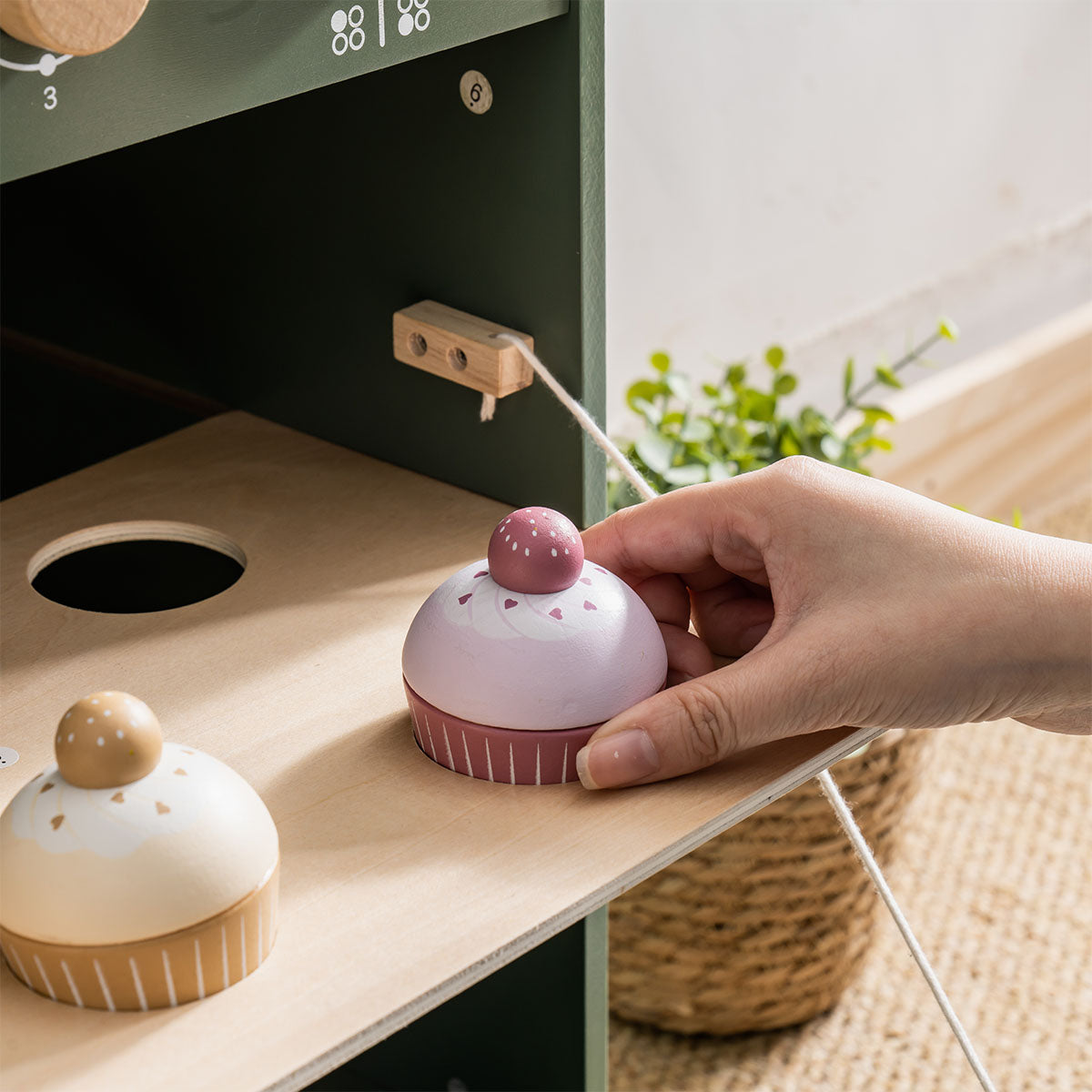 ROBUD vintage oven toy in natural room setting beside counter with play food and accessories.