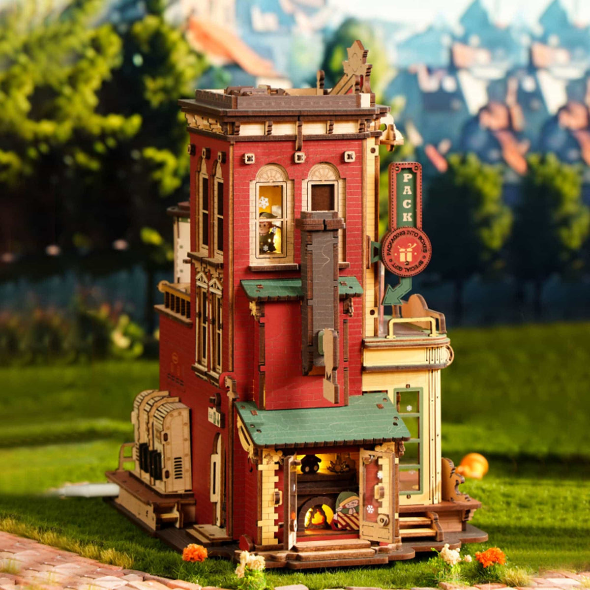 ROKR Dream Gift Factory EAB01 wooden music box assembled exterior view with red multi-story facade on outdoor fantasy green hillside