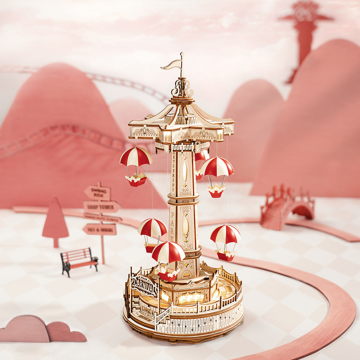 ROKR Parachute Tower music box with red and white gondolas spinning above a circular wooden base in a pastel pink landscape