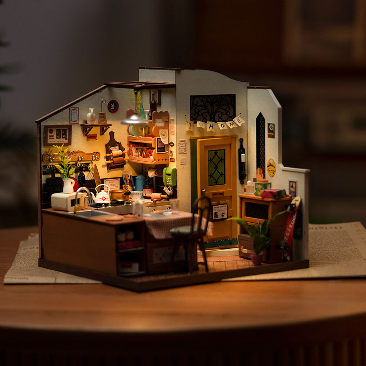 Rolife Cozy Kitchen DIY miniature house fully assembled with warm interior lighting showing tiny counters and appliances