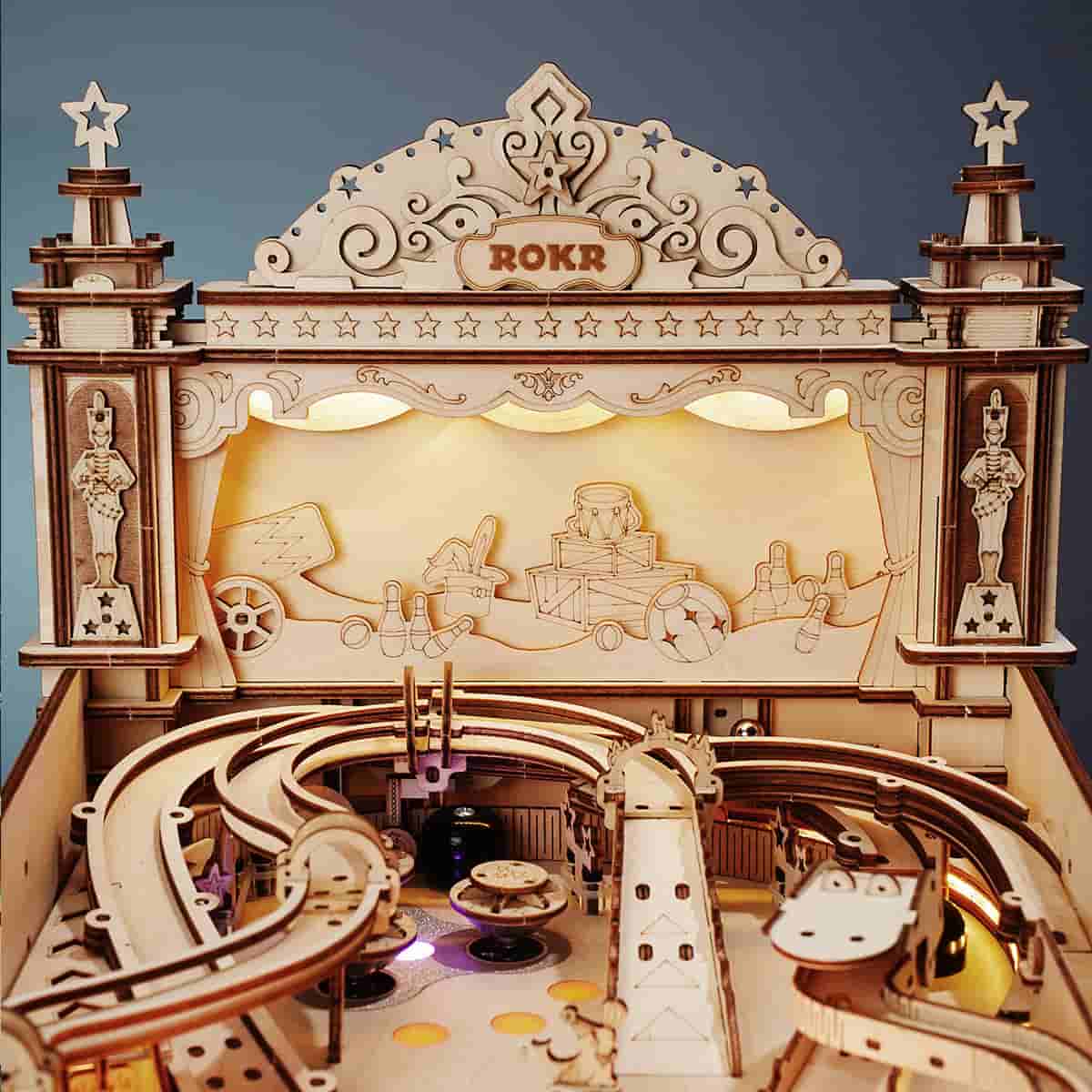 ROKR 3D Pinball Machine close-up of ornate wooden arch marquee with carved lettering and figurines flanking the lit playfield