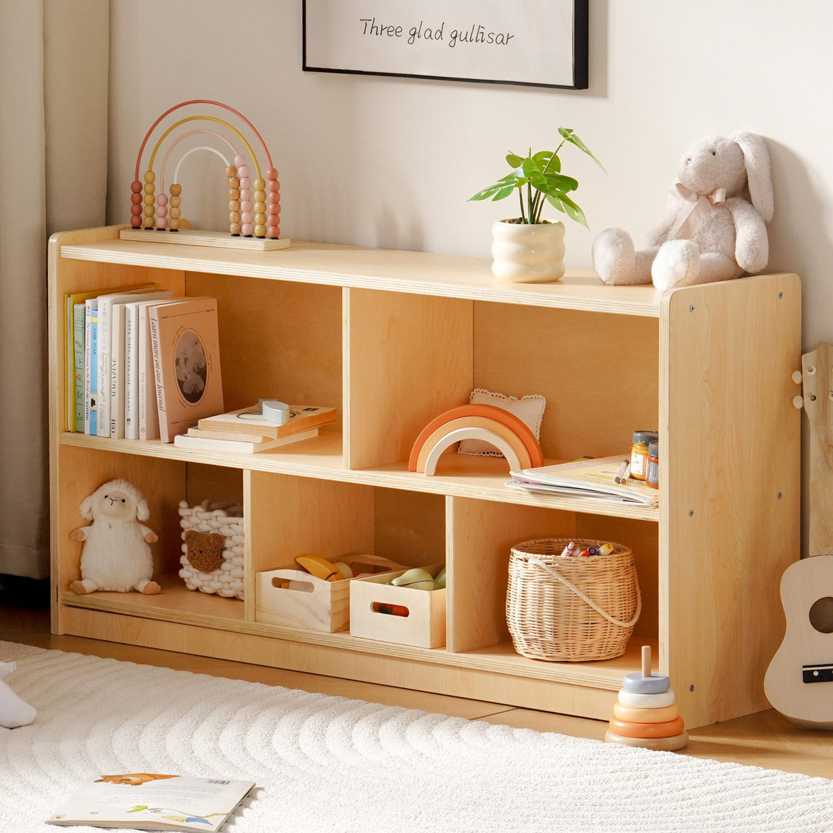 ROBUD five-compartment open wooden bookshelf styled in a playroom with books toys and a rabbit plush on display.