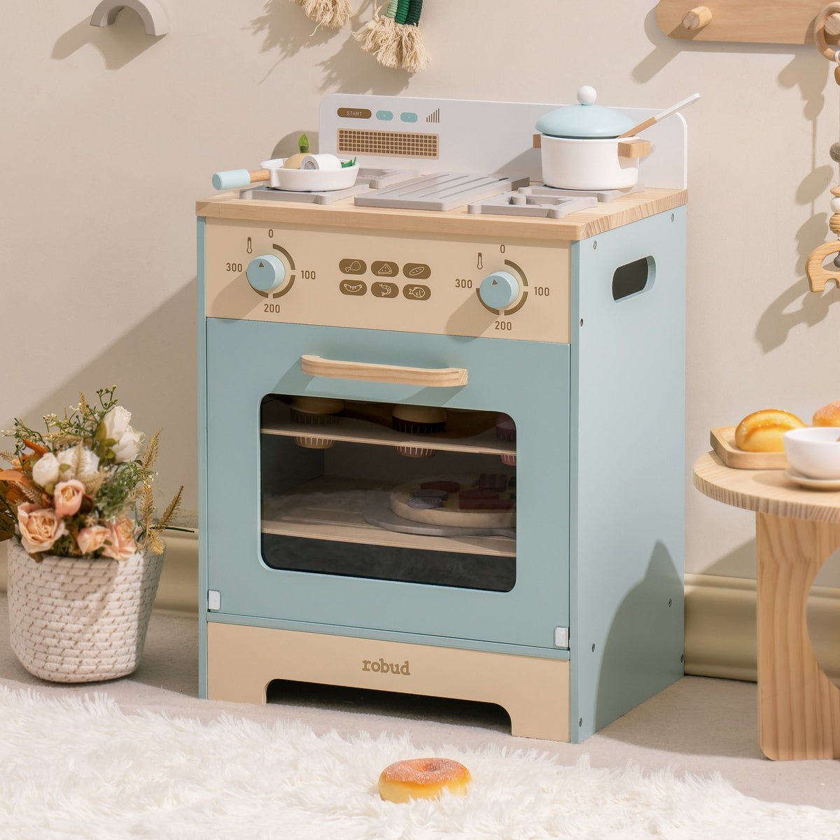 Robud mint blue play oven full front view with gold knobs, window door and natural wood countertop